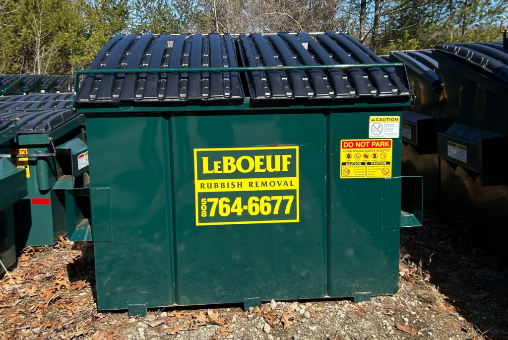 A LeBoeuf Rubbish Removal branded dumpster with locking bar.