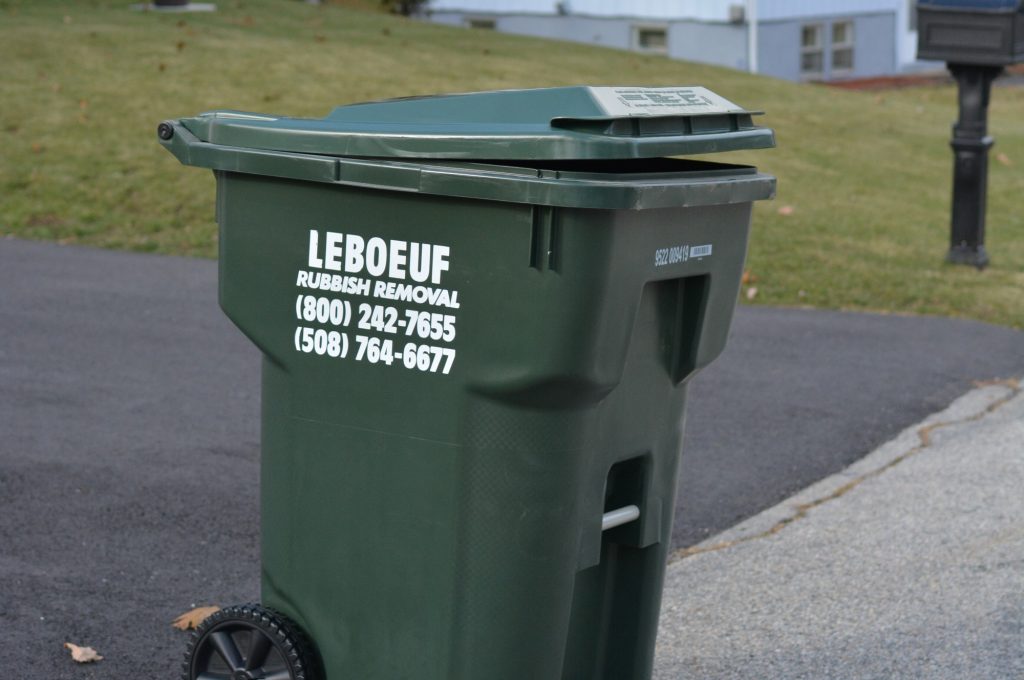 LeBoeuf Rubbish Removal cart sitting at the curb in a residential neighborhood.