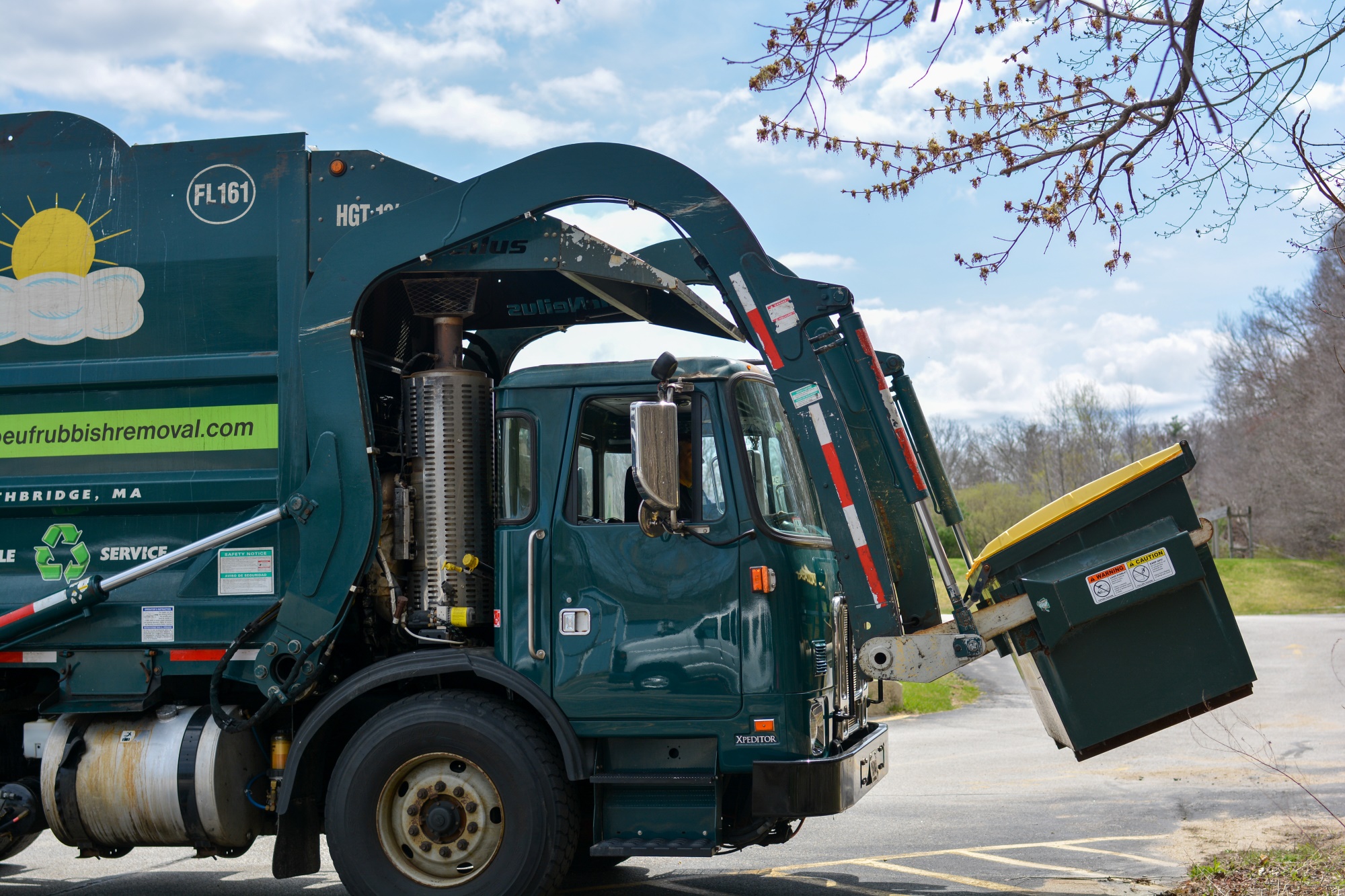 LeBoeuf recycling truck picking up a commercial dumpster.