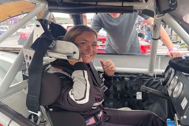 Trinity Provost’s smiling and giving thumbs up in her #07 Racing Car.